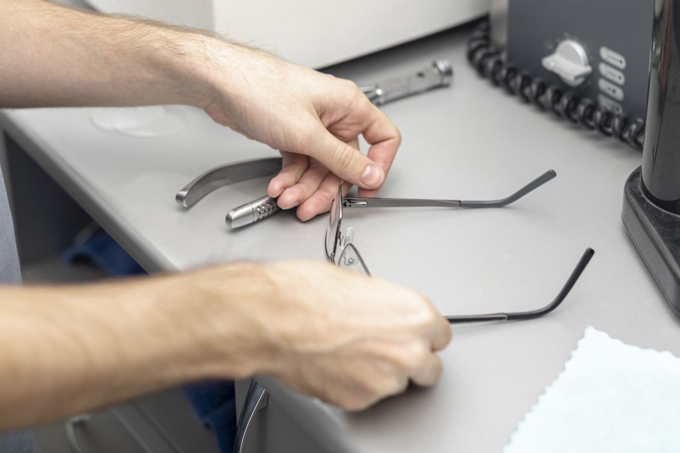 high angle man putting down his glasses desk
