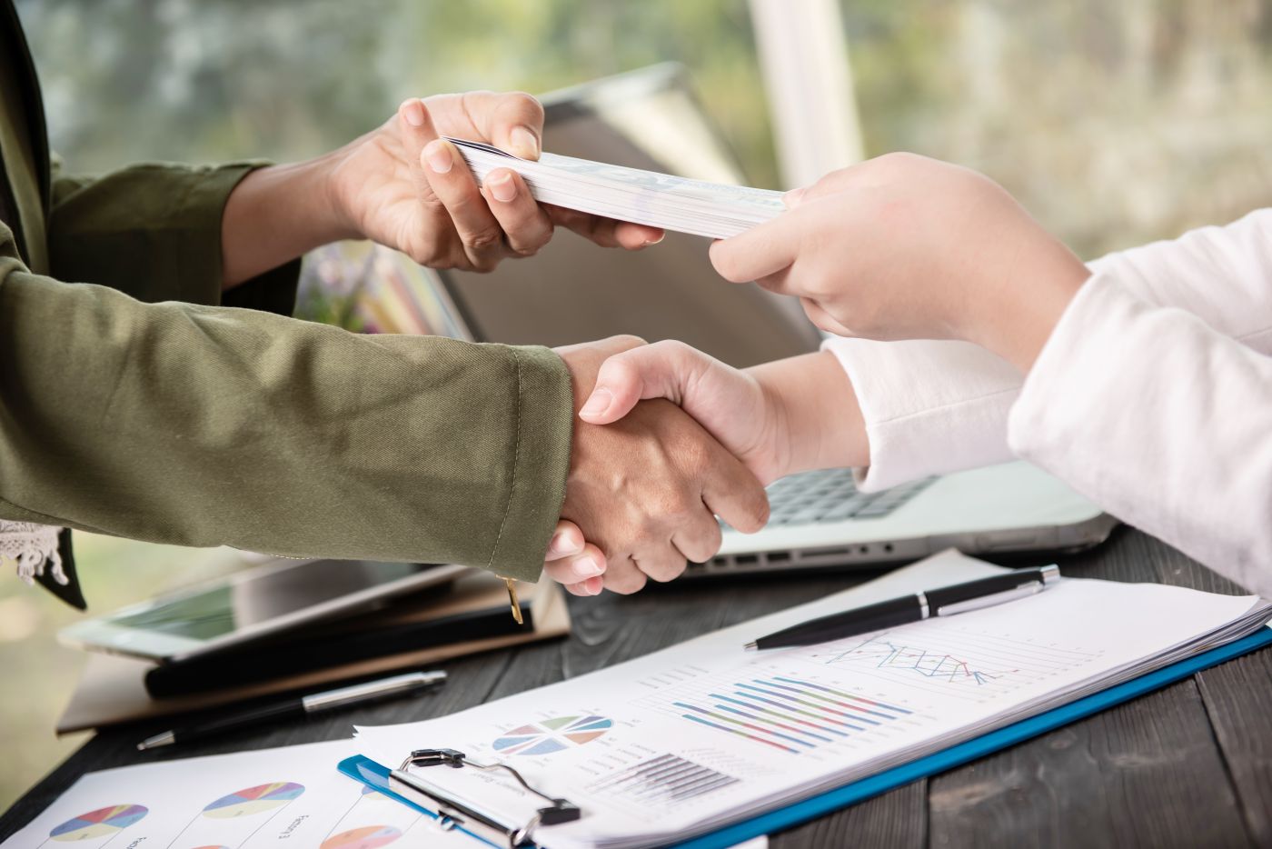 business people shaking hands finishing up meeting